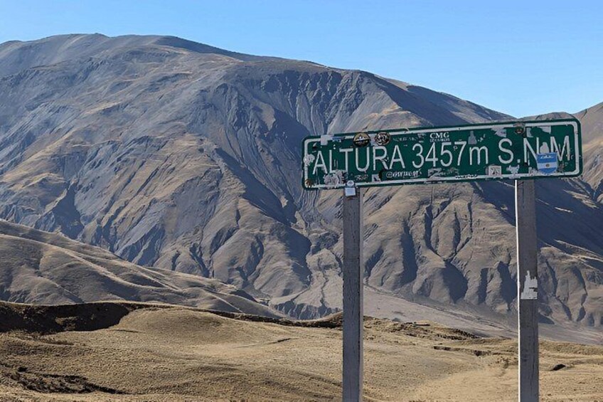A road sign with 'ALTURA 3457m S.N.M' indicating an elevation of 3457 meters. 5