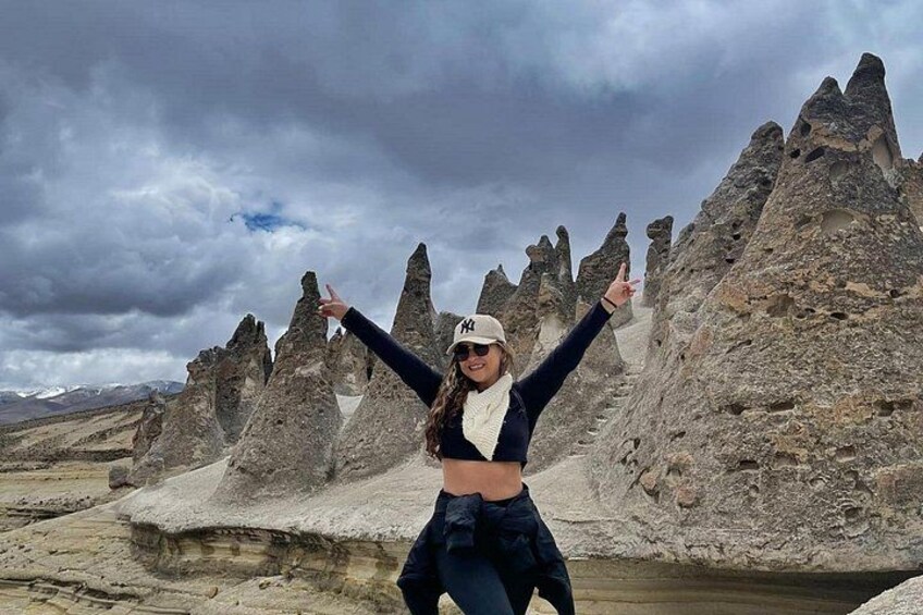 A person standing in a rocky landscape with unique rock formations. 2