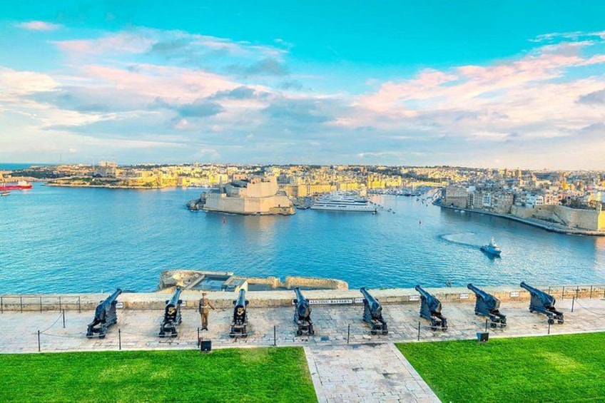 A harbor with ships, a lighthouse, and a row of cannons. 3