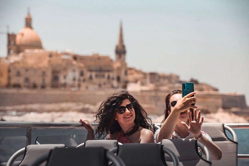 Two people on a boat with a historic building in the background. 5