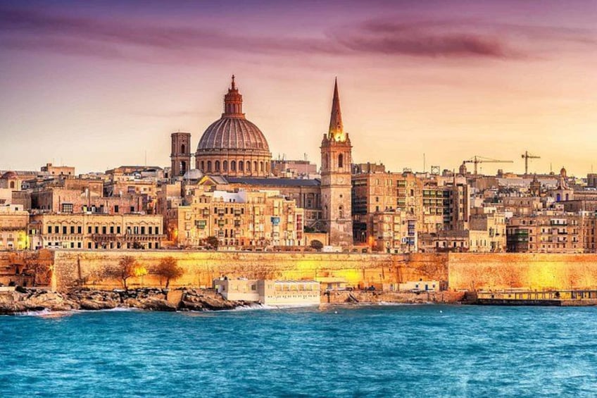 A coastal cityscape with a prominent dome and spire, a bridge, and a rocky shoreline. 3