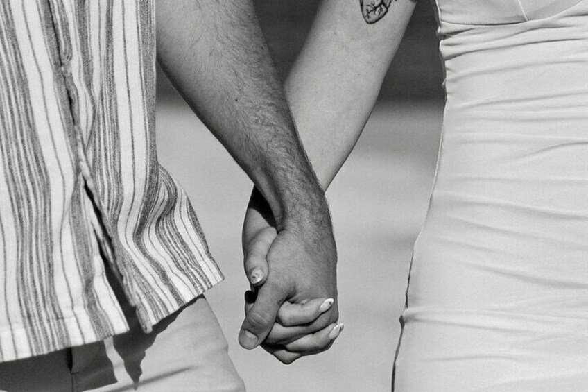 A person holding hands with another, both wearing striped clothing. 2