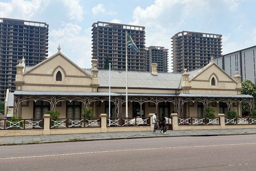 A historic building with a classic architectural style, surrounded by modern high-rise buildings. 4