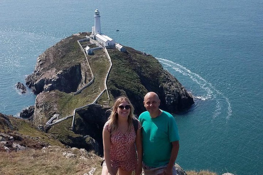A coastal landscape with a lighthouse and a winding path. 3