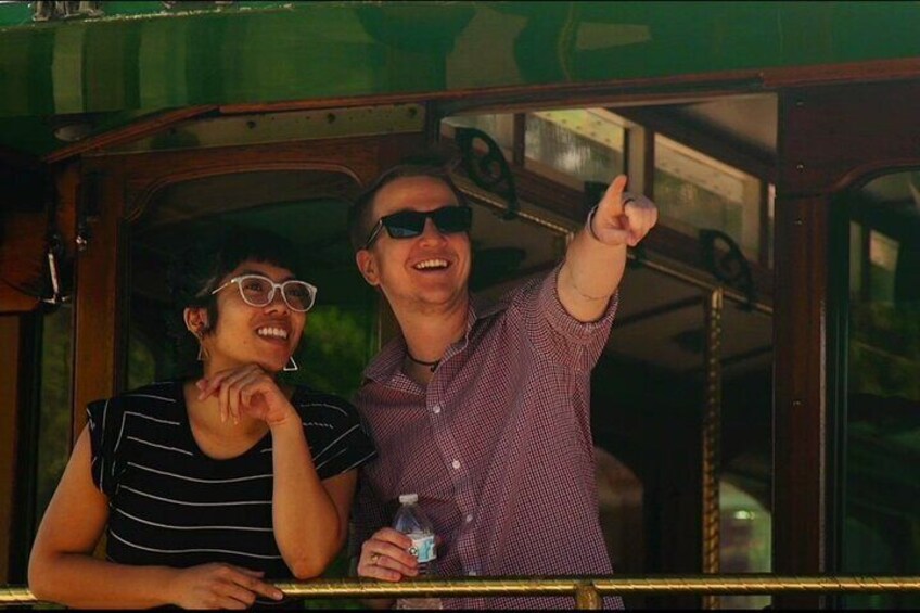 Dos personas en un vehículo, una señalando hacia afuera. 5