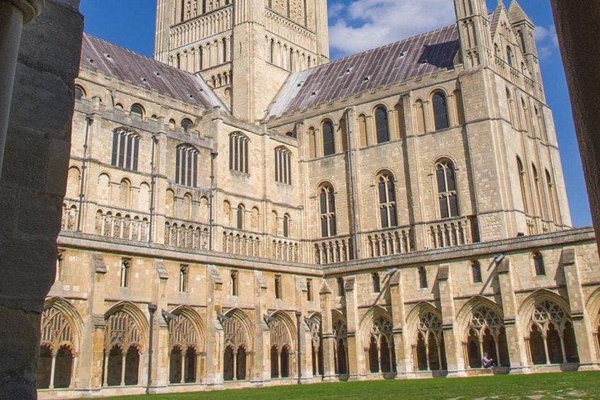A large cathedral with a tall tower, arched windows, and a courtyard. 2
