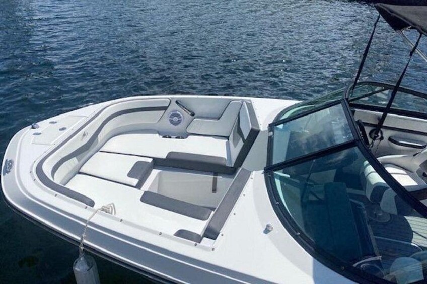 A boat with a cabin, a steering wheel, and a wakeboard. 5