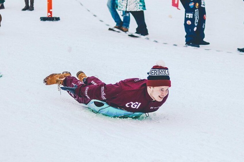 A person sledding on a snowy slope. 4