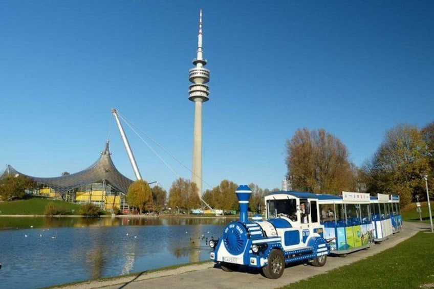 A blue and white train, a tower, and a bridge. 3