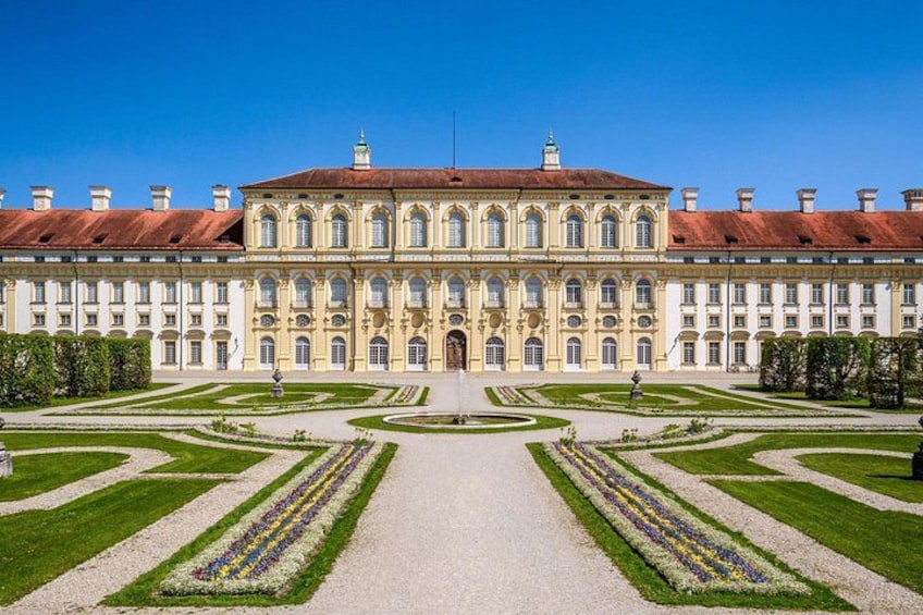 A grand palace with symmetrical gardens and a central fountain. 3