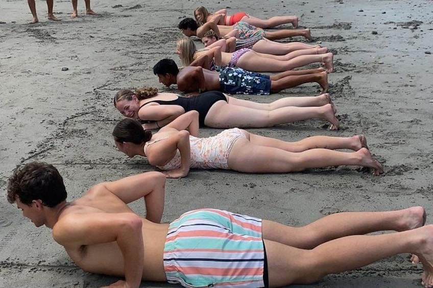 People lying prone on a sandy beach. 4