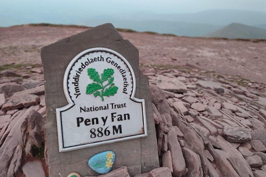 Un cartel con el logotipo de National Trust y el nombre 'Pen y Fan', con una altitud de 886 metros. 3