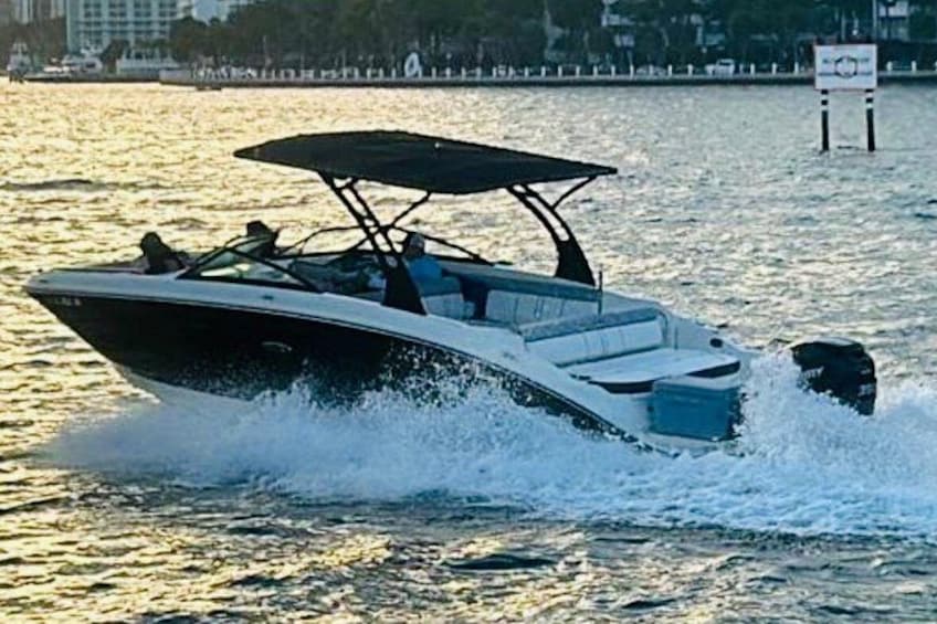 A speedboat with a canopy on the water. 4