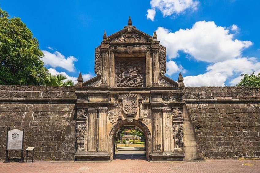 An ancient stone gate with intricate carvings and a clear sky. 3