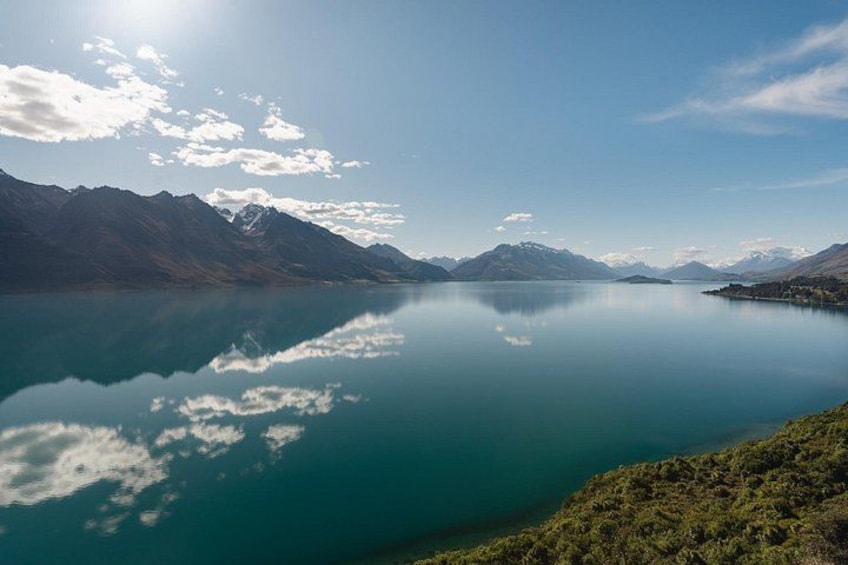 A calm lake with mountains in the background. 4