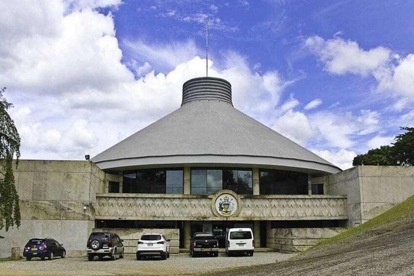 A building with a conical roof and a circular emblem on the front. 4