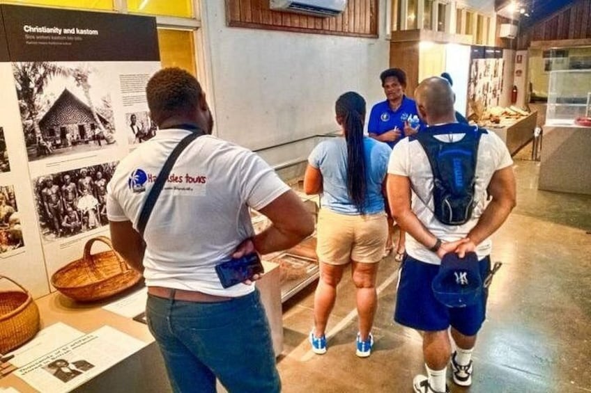 A group of people in a museum, examining exhibits. 5