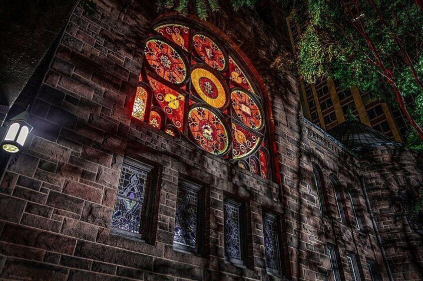 A historic building with ornate stained glass windows and stone masonry. 4