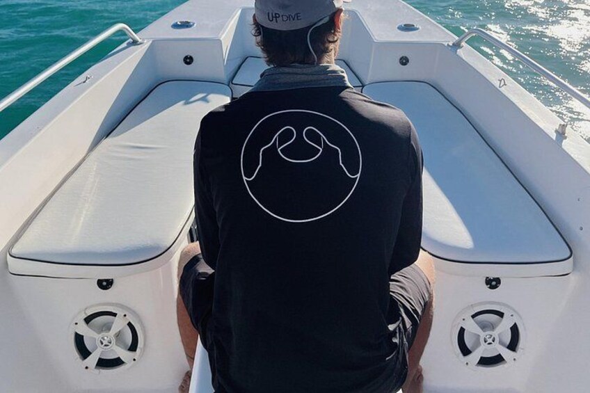 A person on a boat with a logo on the back of their shirt. 2
