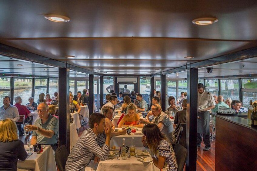 A restaurant with patrons dining inside a boat. 5