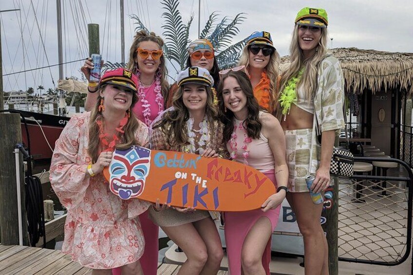 En grupp människor håller upp en skylt med texten: ”Gatsby på Freaky Tiki”. 3
