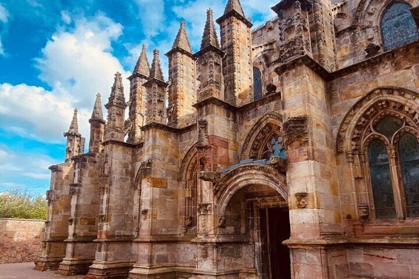 A historic stone building with pointed towers and arched windows. 4