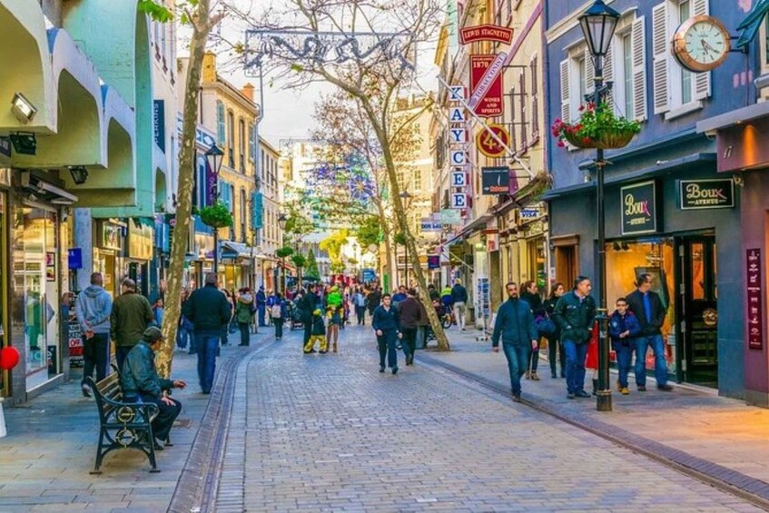 A bustling street lined with shops and pedestrians. 3