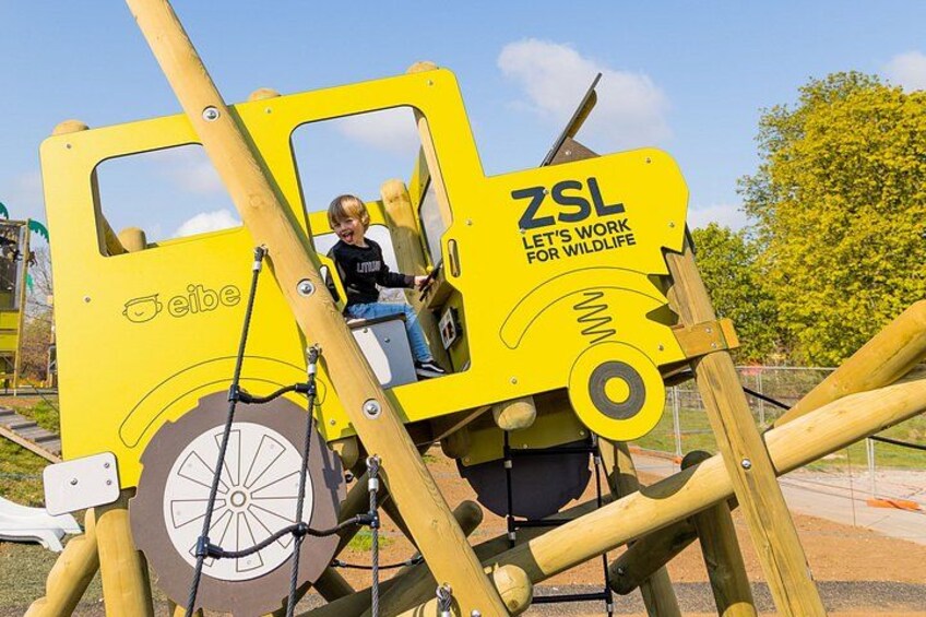 A yellow play structure with a child climbing it. 3
