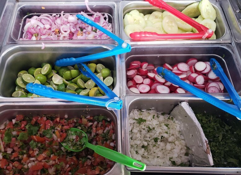 A food display with various ingredients in separate containers. 4