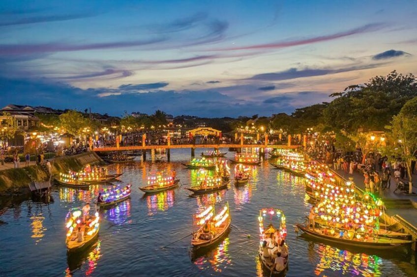 A river with illuminated boats and a bridge. 4