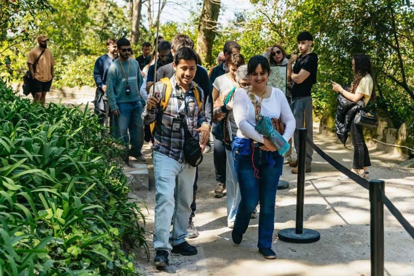A group of people walking on a pathway surrounded by greenery. 4