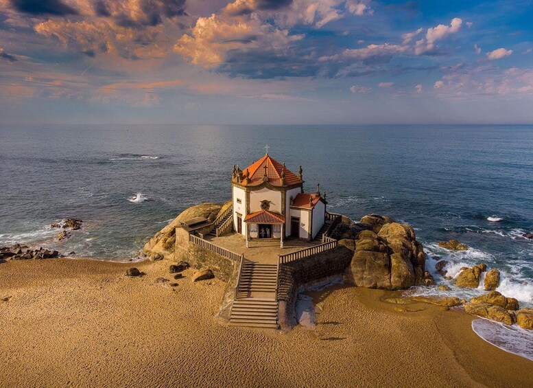 A coastal church on a rocky outcrop with a sea view. 1