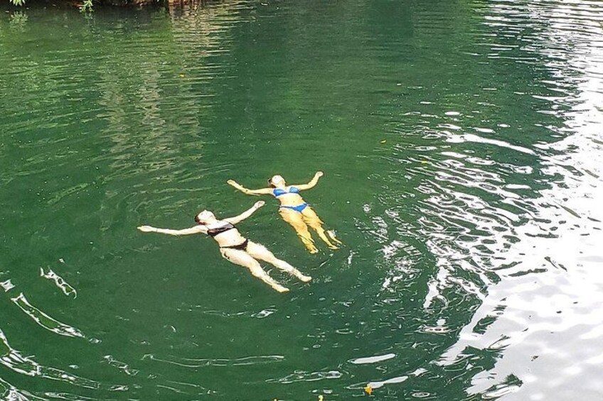 Two people floating on a body of water. 3