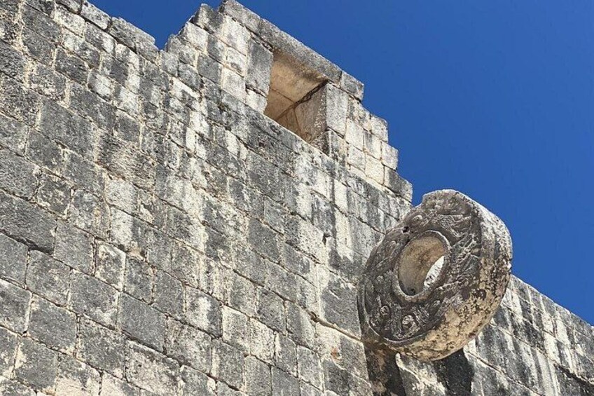 A stone wall with a circular stone structure. 5