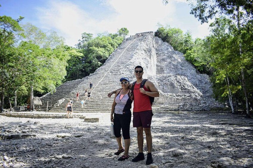 A large pyramid with people walking around it. 4