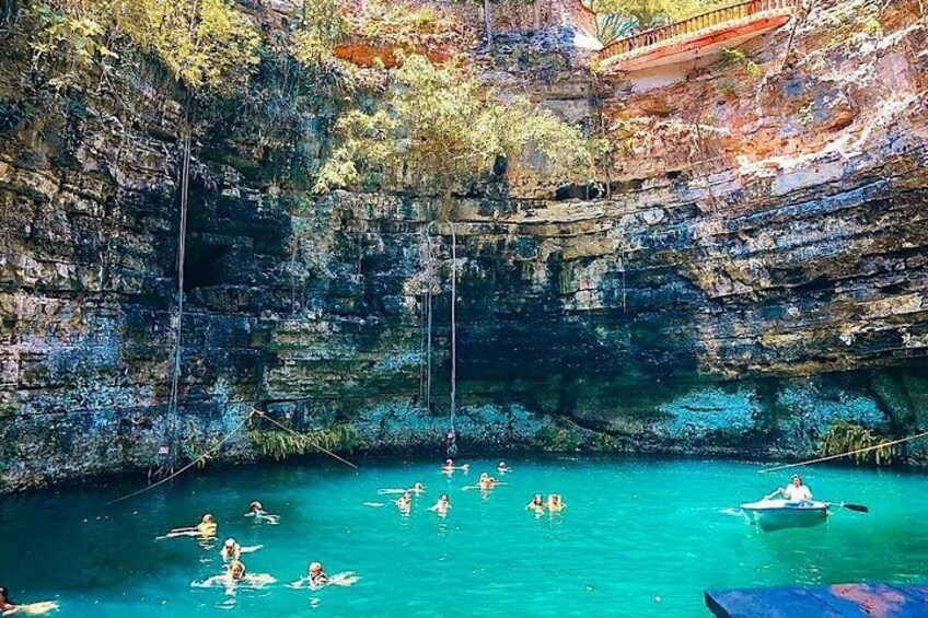 A natural swimming area with clear water, surrounded by rocky cliffs and vegetation. 3