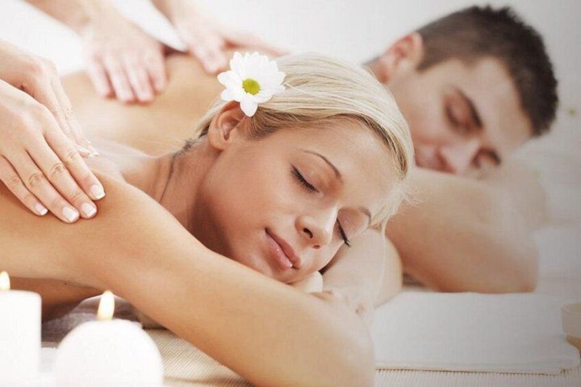 A person receiving a back massage in a spa setting. 4