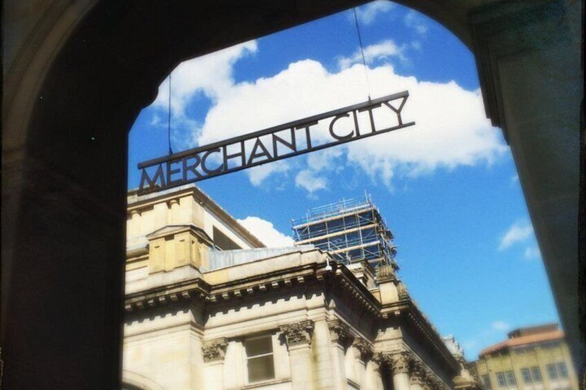 A building with scaffolding and a sign reading 'MERCHANT CITY'. 2
