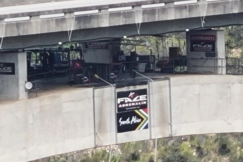 A concrete bridge with a sign for FXZE and a banner for South West. 5