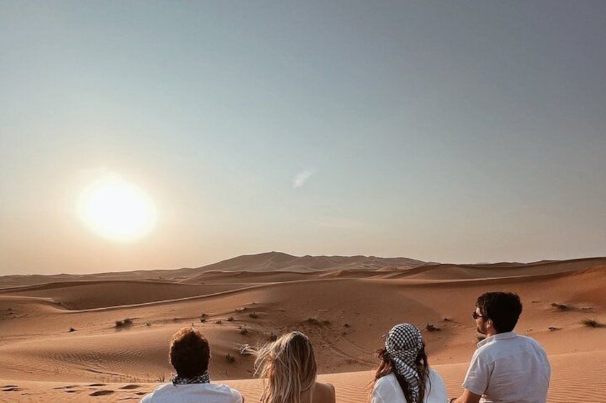 A desert landscape with sand dunes and a clear sky. 3