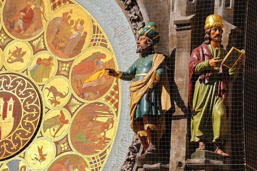 A mosaic with figures and a stone wall. 2