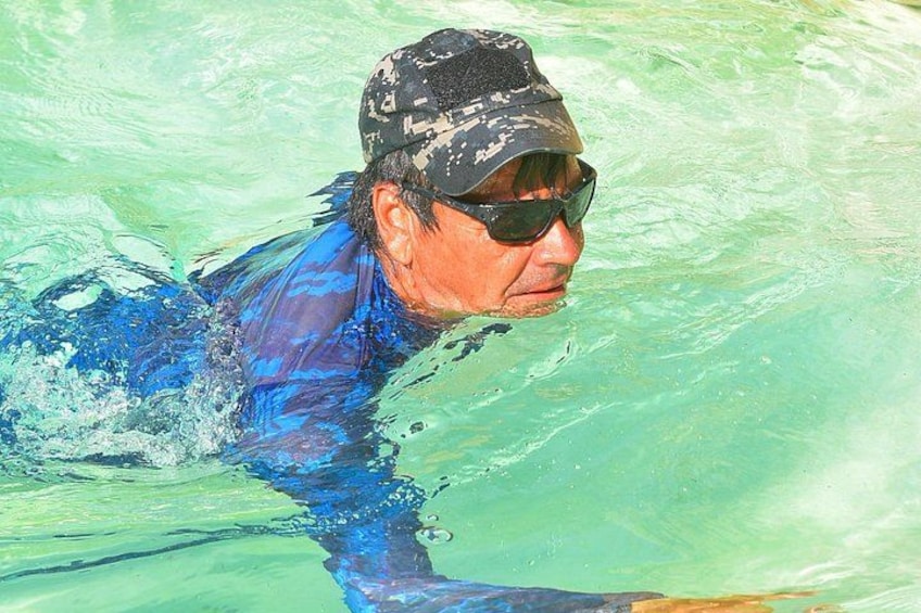 A person swimming in a pool. 3