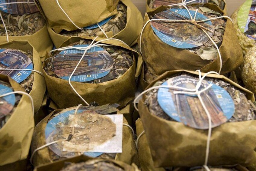 Bundles of dried plants wrapped in brown paper with labels. 3
