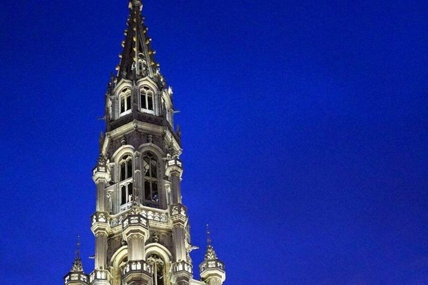 A tall, ornate tower with intricate architectural details against a clear blue sky. 3