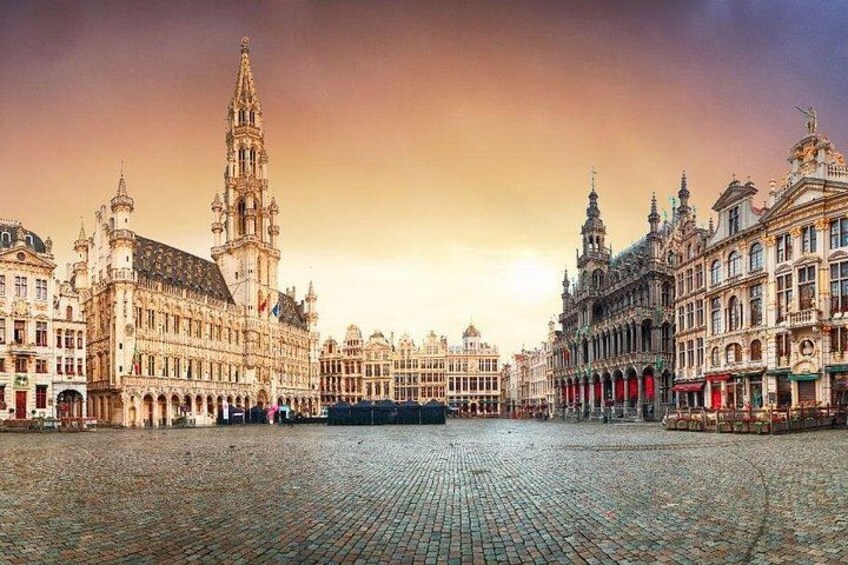 A historic square with ornate buildings, a prominent tower, and cobblestone pavement. 5