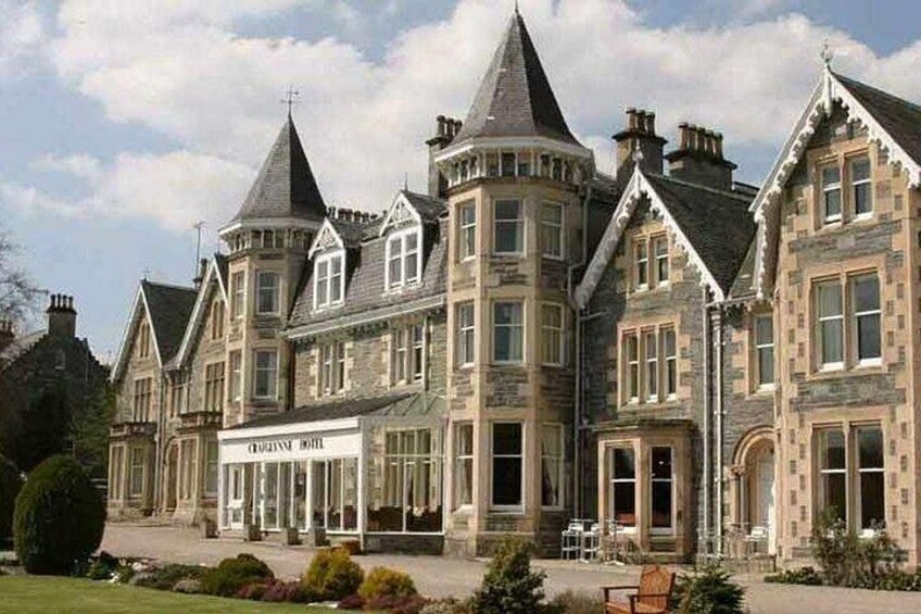 A large, historic building with multiple towers and a prominent entrance. 2