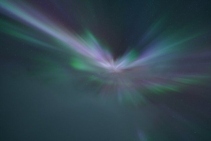 A starry night sky with visible aurora borealis. 2