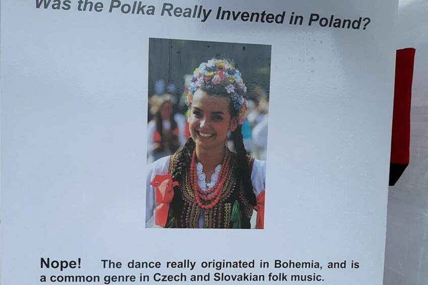 A sign with a photo of a person in traditional Bohemian attire. 4