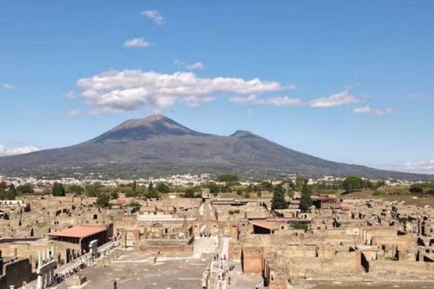 A cemetery with ancient ruins and a volcano in the background. 3