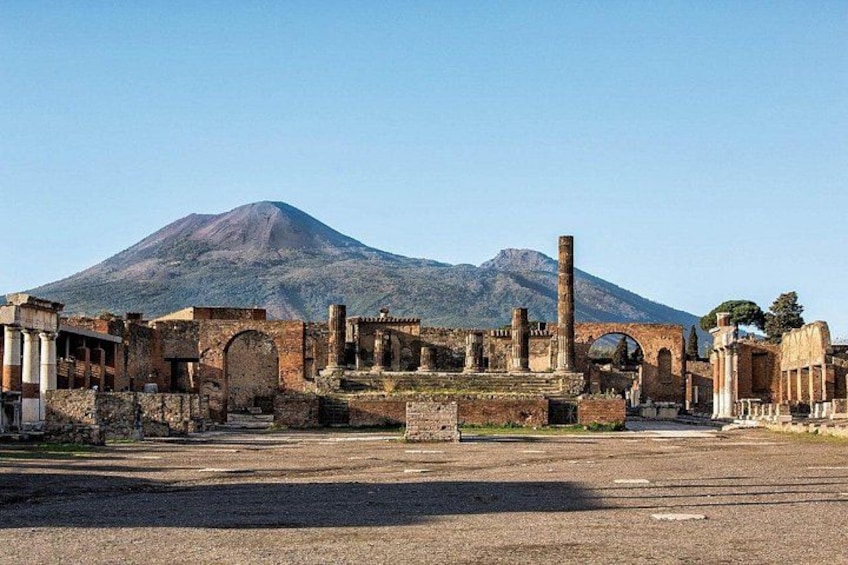 Ancient ruins with columns and arches, a mountain in the background. 5
